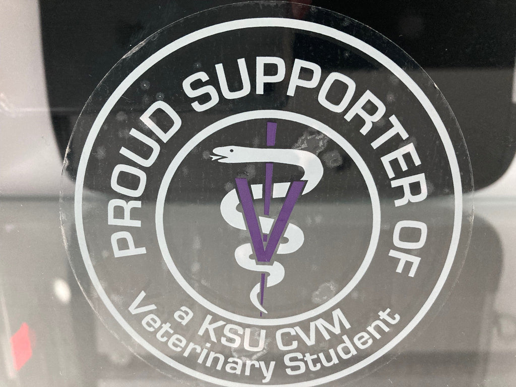 A clear sticker with white wording that reads "Proud Supporter Of a KSU CVM Veterinary Student". 