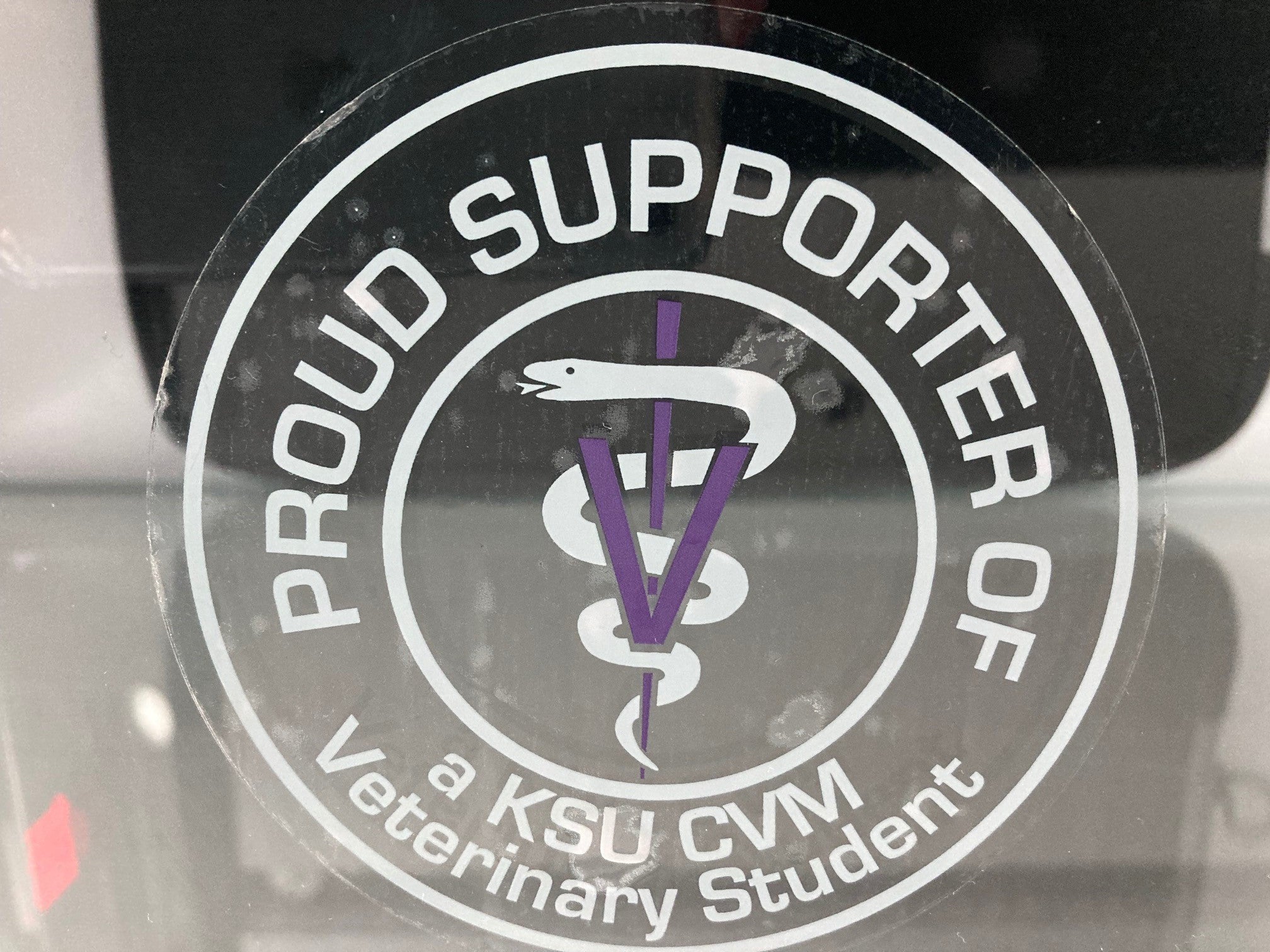 A clear sticker with white wording that reads "Proud Supporter Of a KSU CVM Veterinary Student". 