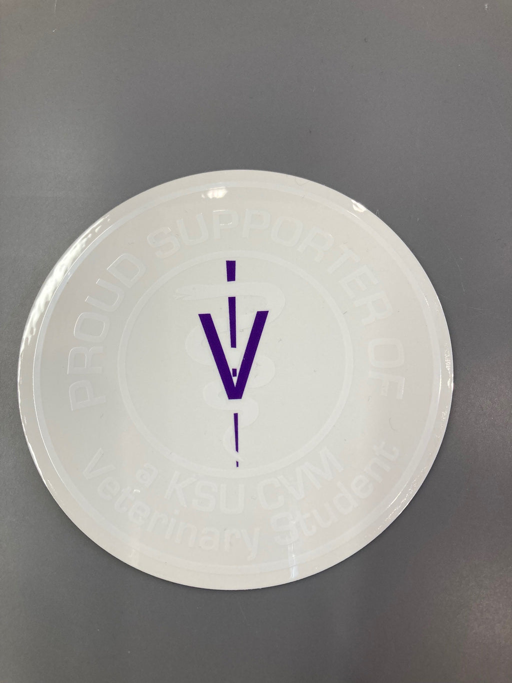 A clear sticker with white wording that reads "Proud Supporter Of a KSU CVM Veterinary Student". 