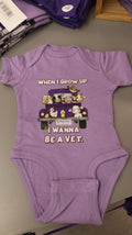 A lavender-colored short sleeve onesie with an illustration of different animals in the back of a truck and the text 'When I grow up I want to be a Vet'.