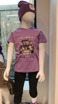 A lavender-colored short sleeve youth t-shirt with an illustration of different animals in the back of a truck and the text 'When I grow up I want to be a Vet'.