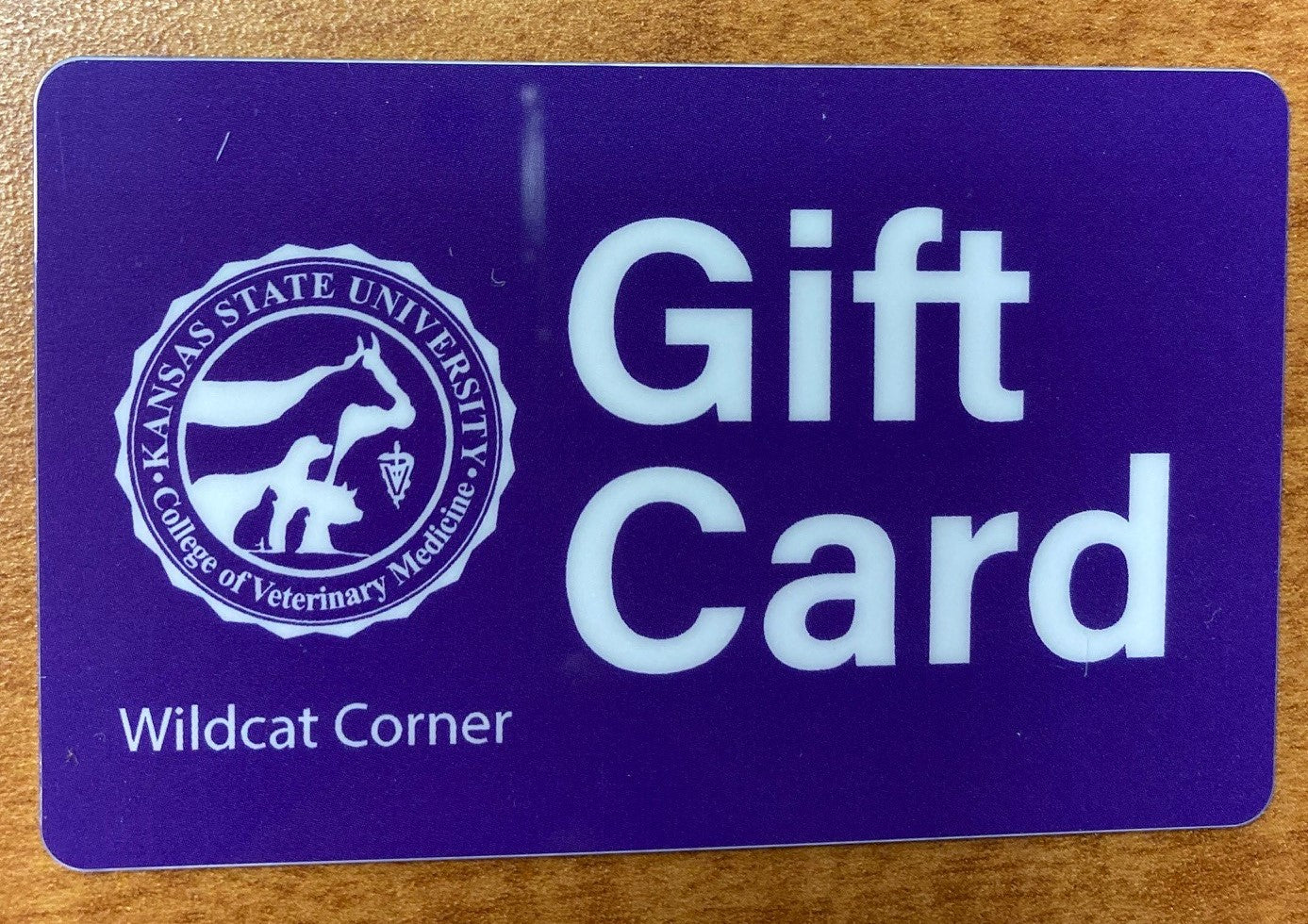 A plastic gift card with a purple background and white text that reads 'GIFT CARD' and the K-State CVM logo. 